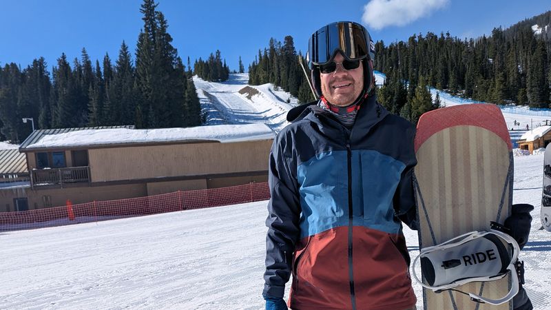 Portrait of Daniel holding homemade snowboard